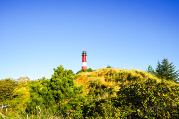View of the red and white Hörnum lighthouse in the south of the island of Sylt.

