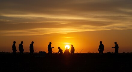 Silhouetted Workers Against a Brilliant Sunset with Warm Tones and Subtle Cloud Patterns