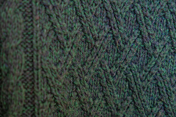 knitted texture, dark green sweater or carpet, pattern of back and front loops. English rubber band. industrial knitting of clothes made of wool, acrylic or cotton. background, knitting.