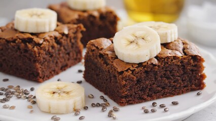 Indulge in this tempting oatmeal brownie topped with fresh banana slices and chia seeds, beautifully captured in macro. This delightful dessert boasts rich flavors, perfect for any baking enthusiast.