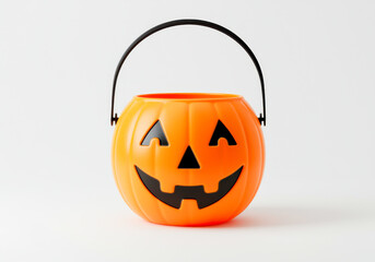 Cute plastic pumpkin halloween candy bucket with smiling face isolated on white background