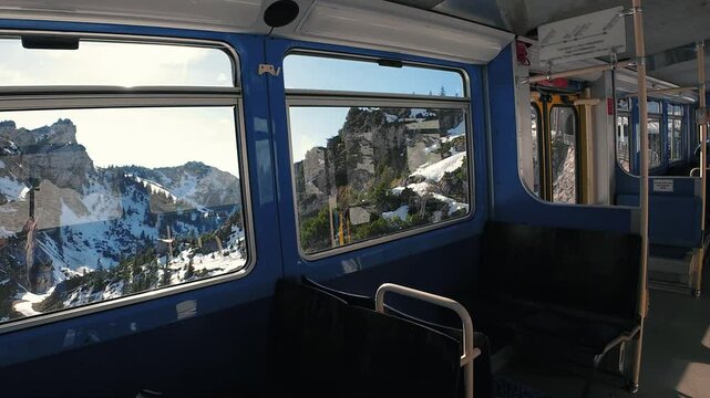 Window view from a cog railway climbing the snowy Wendelstein mountain, in Bavaria, Germany
