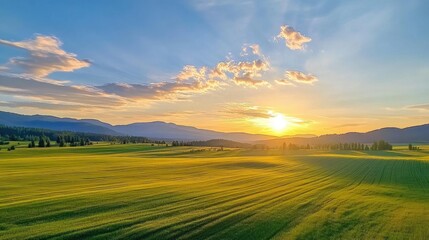 Obraz premium Serene Sunset Over Lush Green Fields and Rolling Hills Under Vibrant Sky Colors