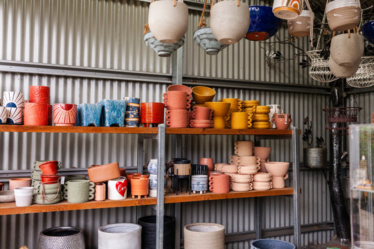 Colourful plant pots for sale in shed at nursery small business