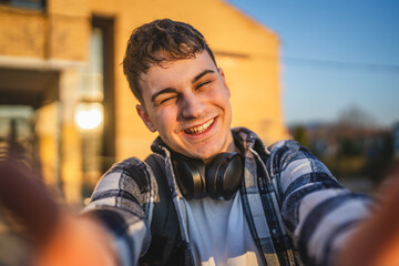 self portrait of young man wear backpack in front university building