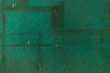 A detailed shot of the textured green surface of an old notice board. The image focuses on the worn and aged fabric, highlighting its vintage character.