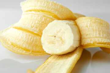 Close up Texture of Peeled Banana Revealing Inner Fruit and Smooth Surface in Bright Lighting on White and Isolated Background