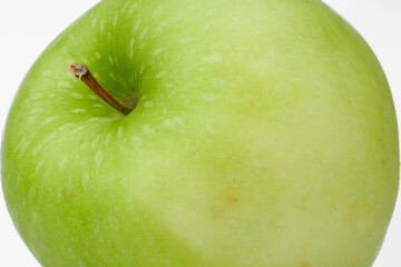 Close up Texture of a Fresh Green Apple Showcasing Its Details and Vibrant Color on White and Isolated Background