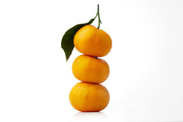 Close up Texture of Stacked Small Oranges With Leaves on White and Isolated Background