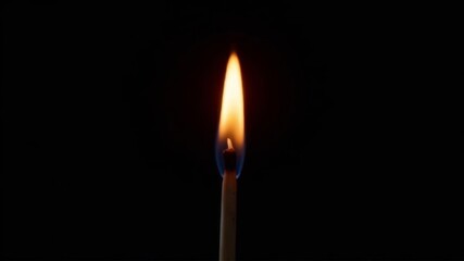 Burning matchstick with bright flame isolated on black background in close-up.