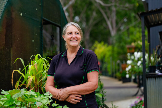 portrait of horticulturalist businesswoman standing in front of nursery garden small business