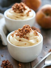 Two bowls of pear dessert with a spoon on the table