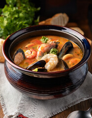 A Croatian seafood soup made with shrimp, mussels, and white fish, served in a large, rustic bowl.