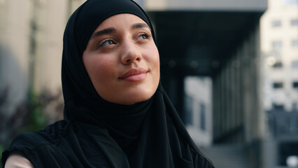 Portrait happy smiling dreaming inspired hopeful mindfulness Muslim positive Islamic woman wearing hijab businesswoman business female girl in city outdoor smile carefree thinking dream religion faith