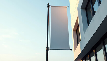 Flag banner mockup. Blank flag banner template on pole — vertical white banner mockup displayed in urban environment with minimal architecture and clear sky.
