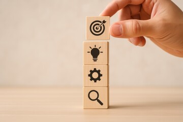 Fototapeta na wymiar Innovative Strategies for Achieving Goals A Hand Stacking Wooden Blocks with Icons Representing Ideas and Tools