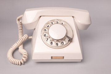 Vintage dial telephone. Isolated olive green telephone on gray background. Old fashioned technology. 