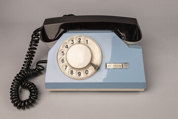 Vintage dial telephone. Isolated olive green telephone on gray background. Old fashioned...