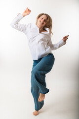 A slim beautiful blond woman poses in full body against a white background. © Zelma
