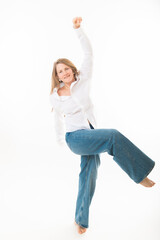 A slim beautiful blond woman poses in full body against a white background.