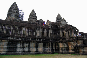Naklejka premium Ancient ruins antique building castle Khmer Empire of Angkor Wat for cambodian people and foreign travelers travel visit respect praying in largest religious temple city complex in Siem Reap, Cambodia