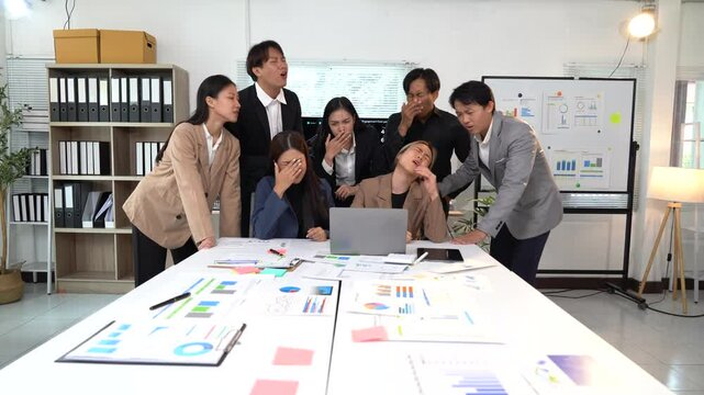 Office workers feeling stressed and frustrated after reviewing bad financial reports on a laptop during a business meeting, expressing disappointment and concern