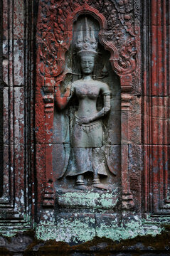 Sculpture carving figure apsaras or apsara angel deity female spirit of clouds waters and superb art of dancing in Prasat Ta Prohm or Ancestor Brahma temple of Angkor Thom Wat in Siem Reap, Cambodia