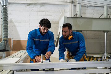Plywood processing plant. Furniture manufacturing. Carpenter working with cnc cutting to cutting...