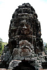 Naklejka premium Sculpture carving ancient ruins antique building of Prasat Bayon Castle or Jayagiri Brahma Temple for Cambodian people and travelers travel visit respect pray at Angkor Thom Wat in Siem Reap, Cambodia