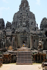 Fototapeta premium Sculpture carving ancient ruins antique building of Prasat Bayon Castle or Jayagiri Brahma Temple for Cambodian people and travelers travel visit respect pray at Angkor Thom Wat in Siem Reap, Cambodia