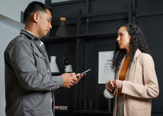 Two Professionals Engaged in Conversation About Business in an Office Setting