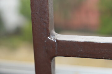 close up of a black metal pipe in the window blur background