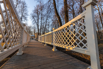 A white wooden bridge with a lattice design