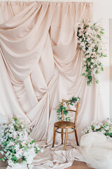 Elegant floral backdrop with golden chair for a special occasion setup
