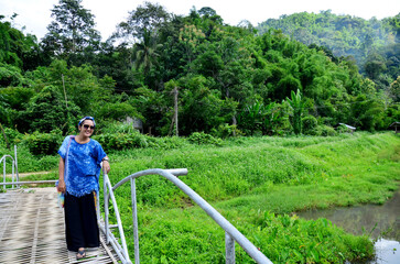 Thai woman portrait on Bamboo bridge at Baan Natong villag