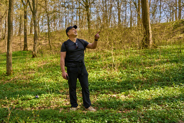 Fototapeta premium Man pointing in spring forest.........