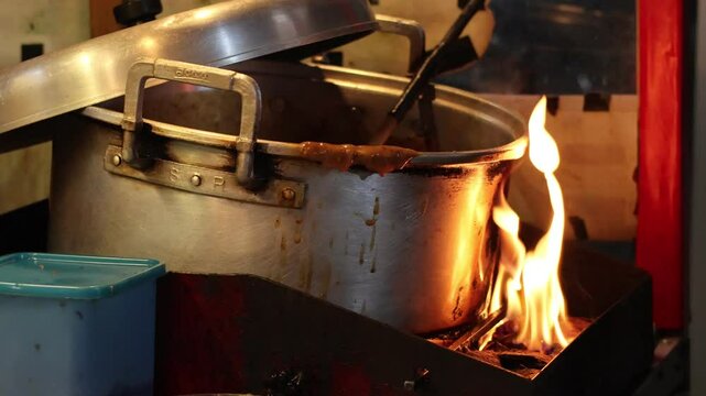 Preparation for making peanut sauce traditionally in a large pan for Padang satay.