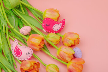 Gentle Easter composition with tulips flowers and handmade felt birds. Traditional elements