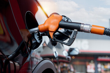 Transport and industry concept. Refilling the car. A refueling valve is inserted into the fuel...