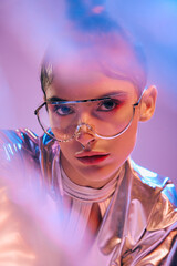 Stylish woman showcases holographic fashion in a vibrant futuristic setting