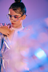 Stylish woman in holographic attire embodies futuristic fashion in vibrant setting