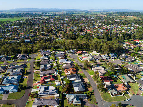 Houses lining street in residential part of country town seen from aerial view