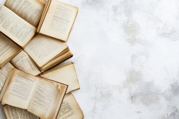 Obraz premium Open vintage books scattered on a textured background inviting exploration and learning