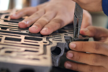 Close up hand repair Automatic transmission control center variator gearbox valve body, details of the automatic transmission oil line, iron labyrinth.