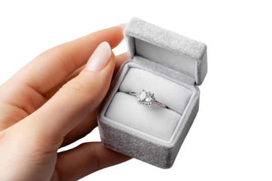 Delicate hand gently presenting a small jewelry box with soft velvet texture a romantic gesture for a special occasion like an engagement anniversary or proposal