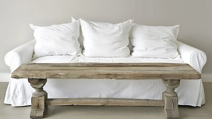 A comfortable sofa with pillows and a rustic wooden table