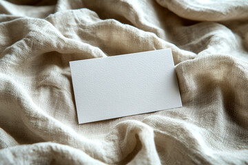 Blank business card on textured creamy fabric background,   mockup for design