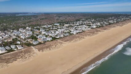 Aerial view of Virginia Beach, VA real estate beach front homes and vacation rentals along the peaceful ocean front coastline with coastal sand dunes