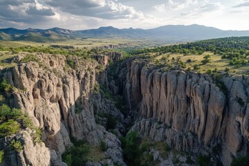 Dramatic canyon cliffs with jagged edges, captured in panoramic aerial view