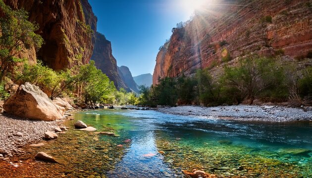 Crystal clear water flowing through todra gorge in morocco's high atlas mountains